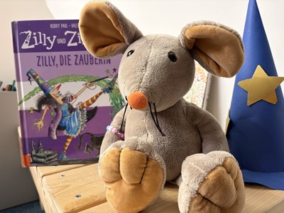 Bini-Maus freut sich auf die nächste Vorlesestunde.