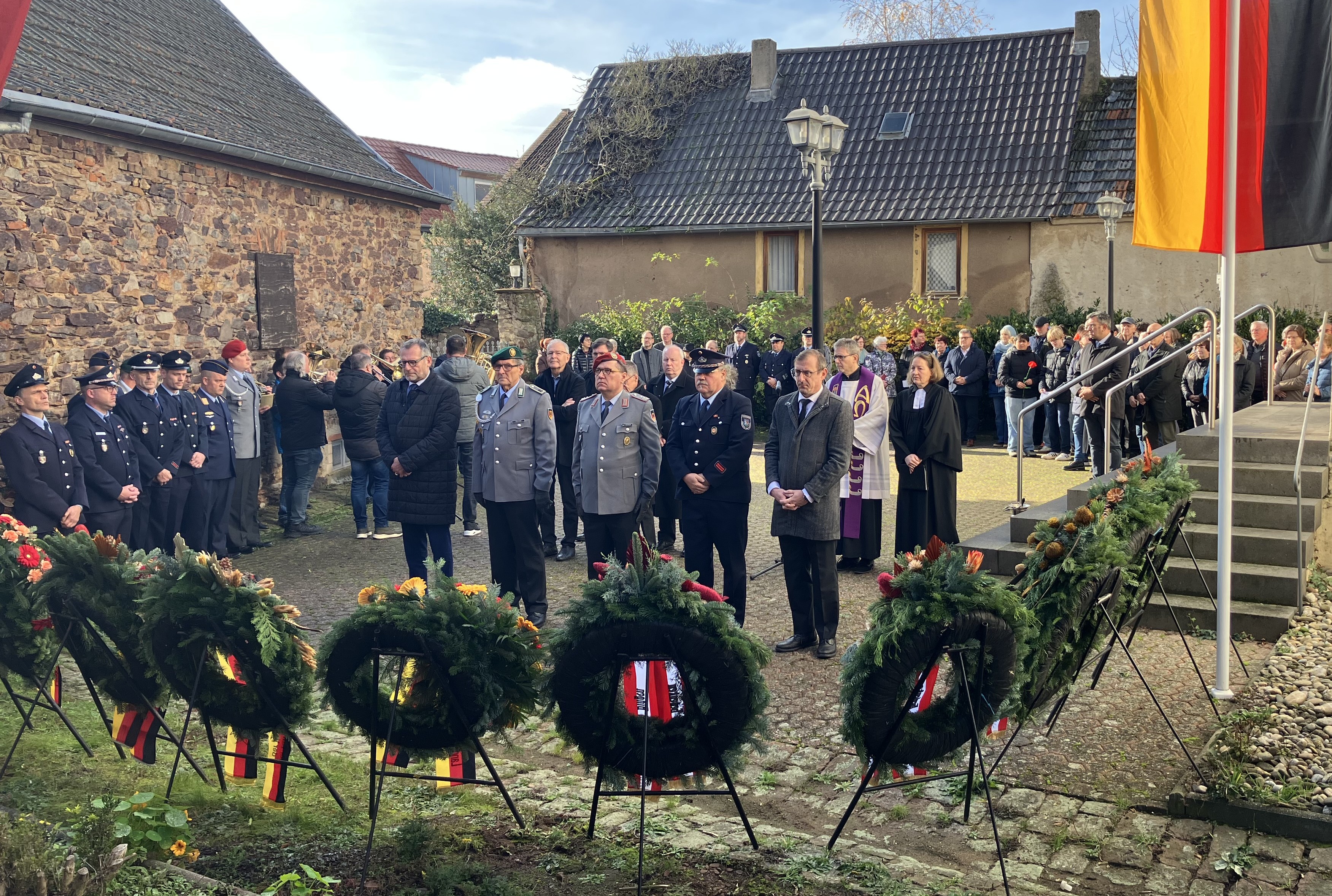 (v.l.n.r.) Oberbürgermeister Thomas Feser, Vertreter von Reservistenkameradschaft, Bundeswehr und Feuerwehr sowie Landrat Thomas Barth bei der Kranzniederlegung