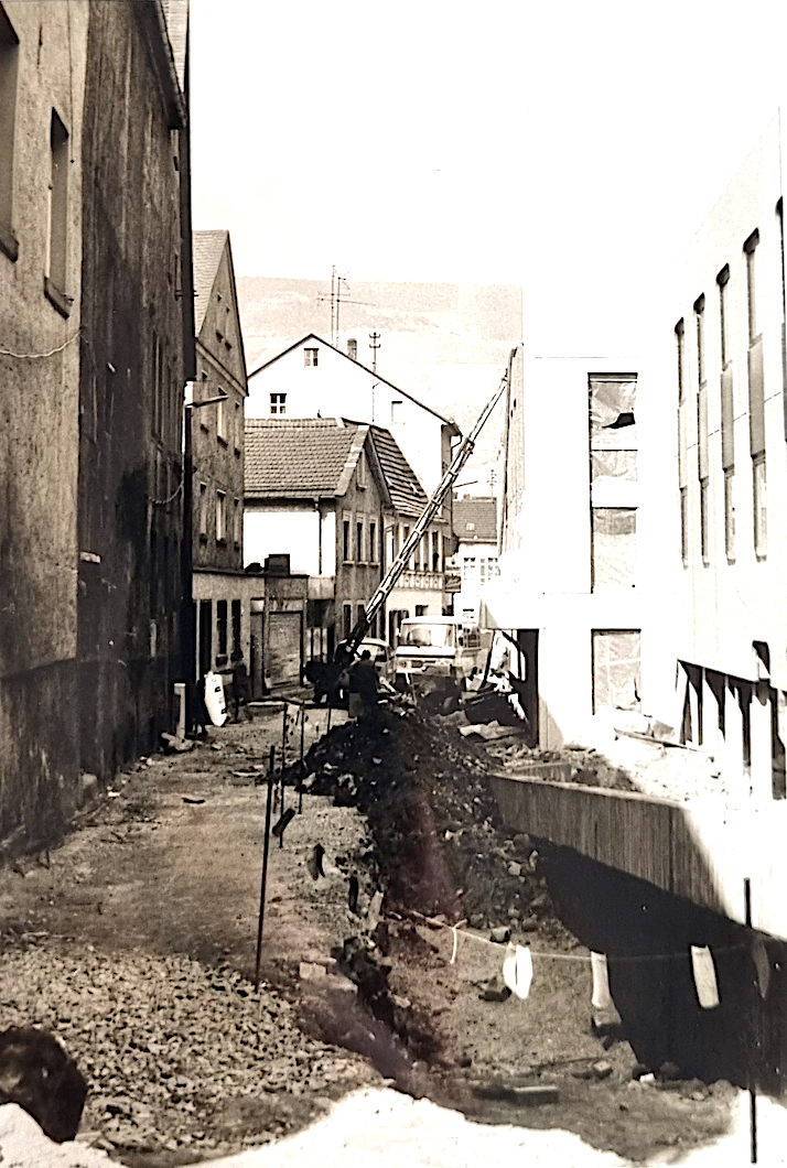 Dies kann man auch gut auf dem Foto mit der Kaufhausgasse und der seitlichen Rampe erkennen, die das Niveau ausgleicht.