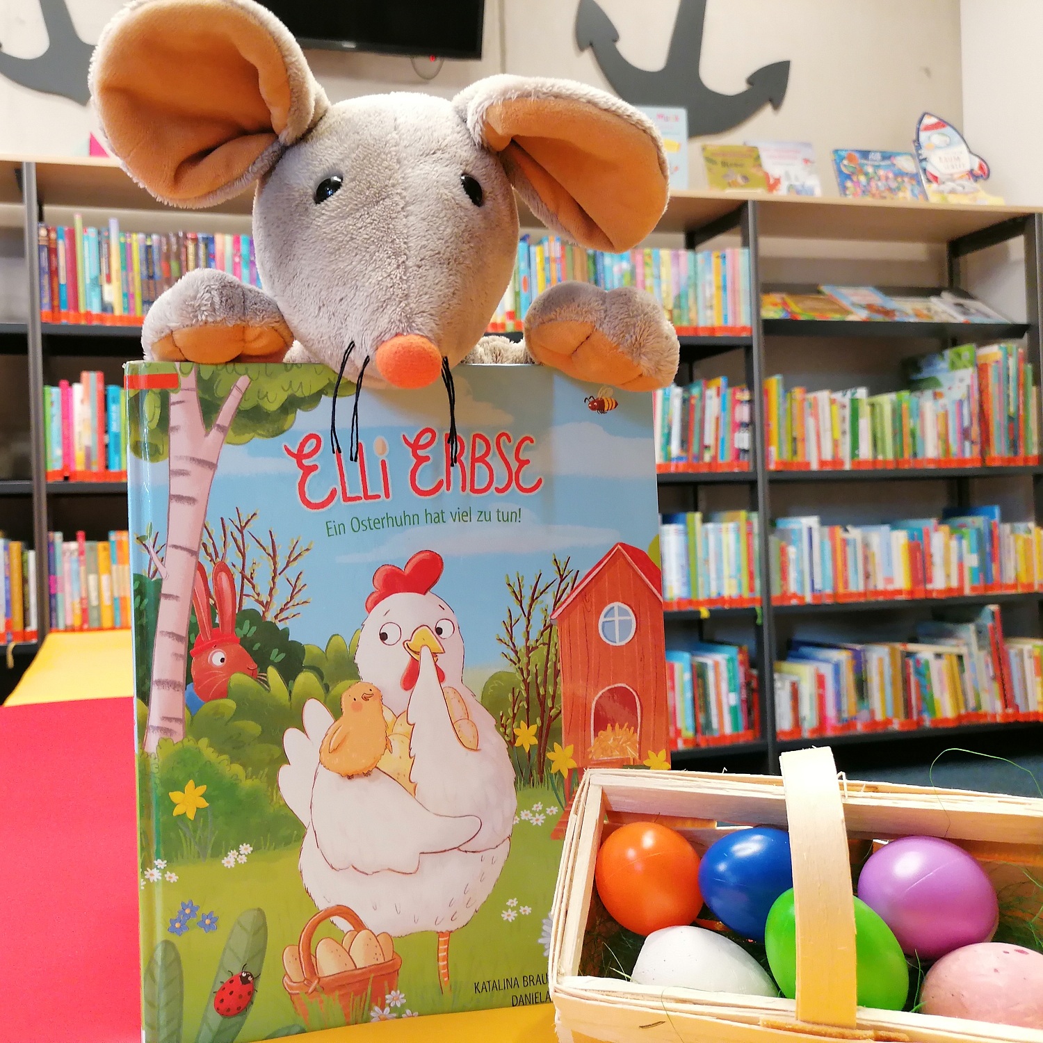 Bini-Maus freut sich auf die Oster-Vorlesestunde.